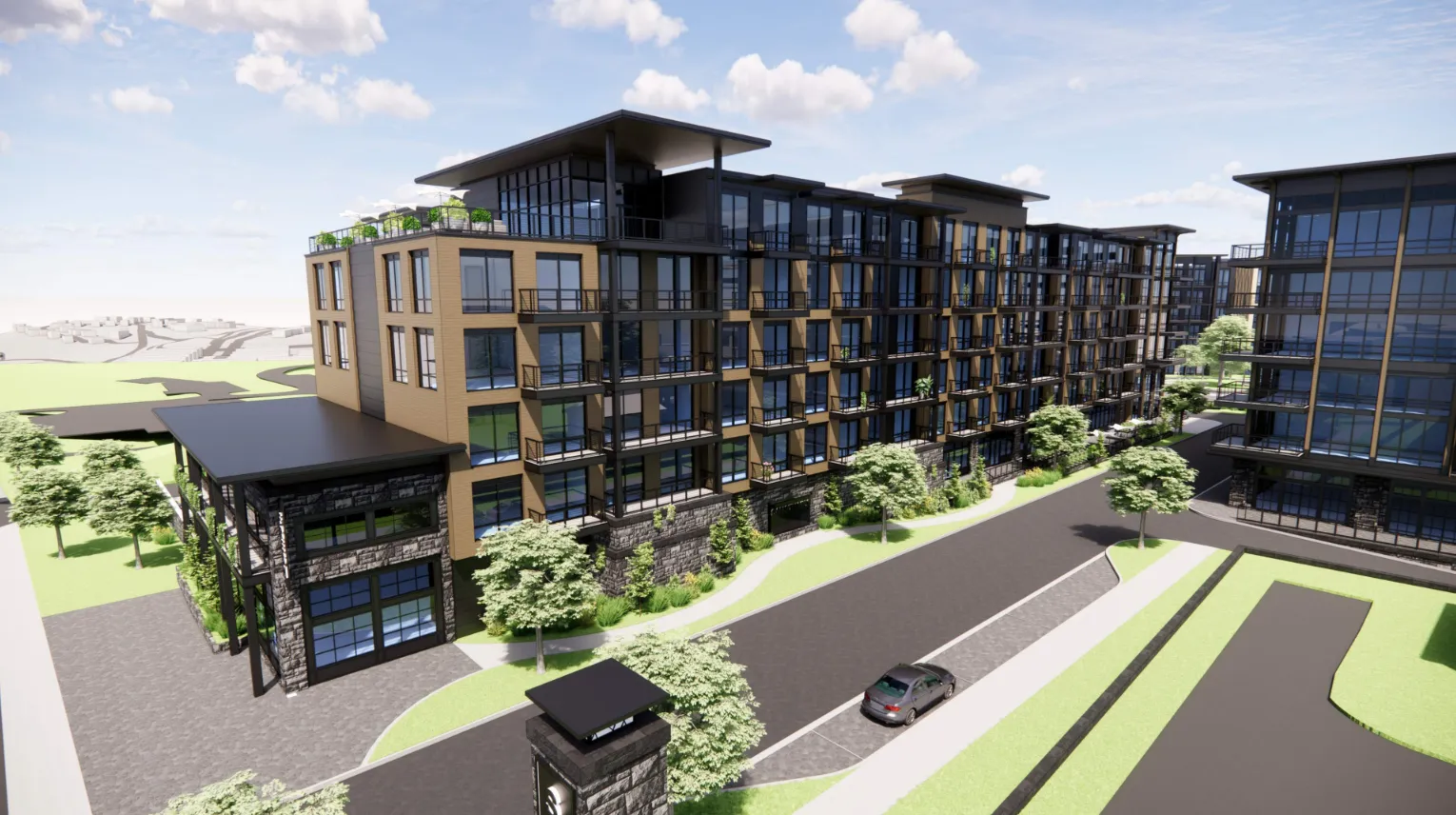 Rendering of a modern apartment complex with multiple stories, featuring large glass windows and a mixture of brick and metal materials. The landscape includes green lawns, trees, and a road with a parked car, set against a blue sky.