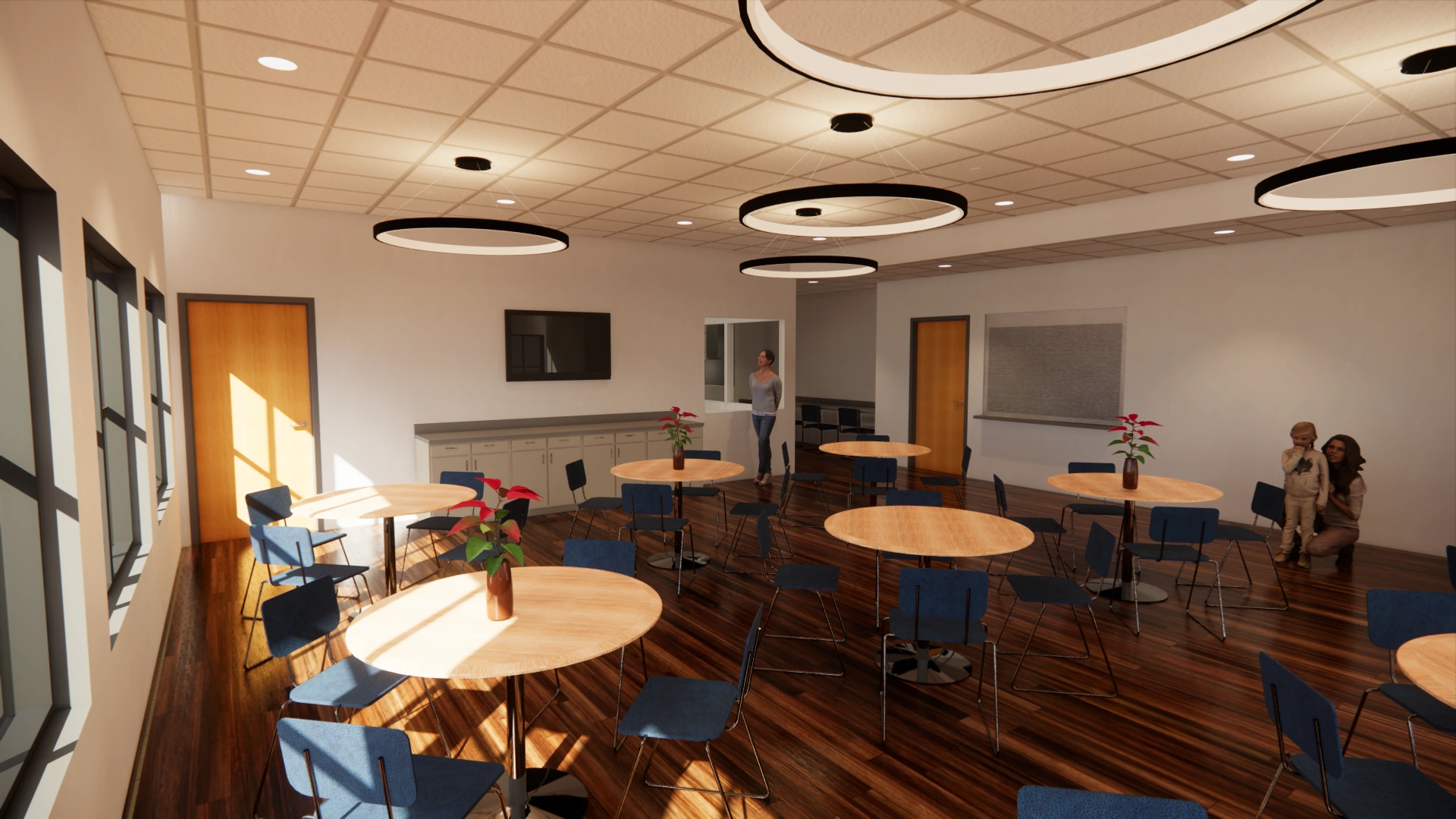 A modern room with round tables and blue chairs on glossy wooden floors. Circular ceiling lights and large windows illuminate the space. A television is mounted on the wall. Two people stand near a door at the back.