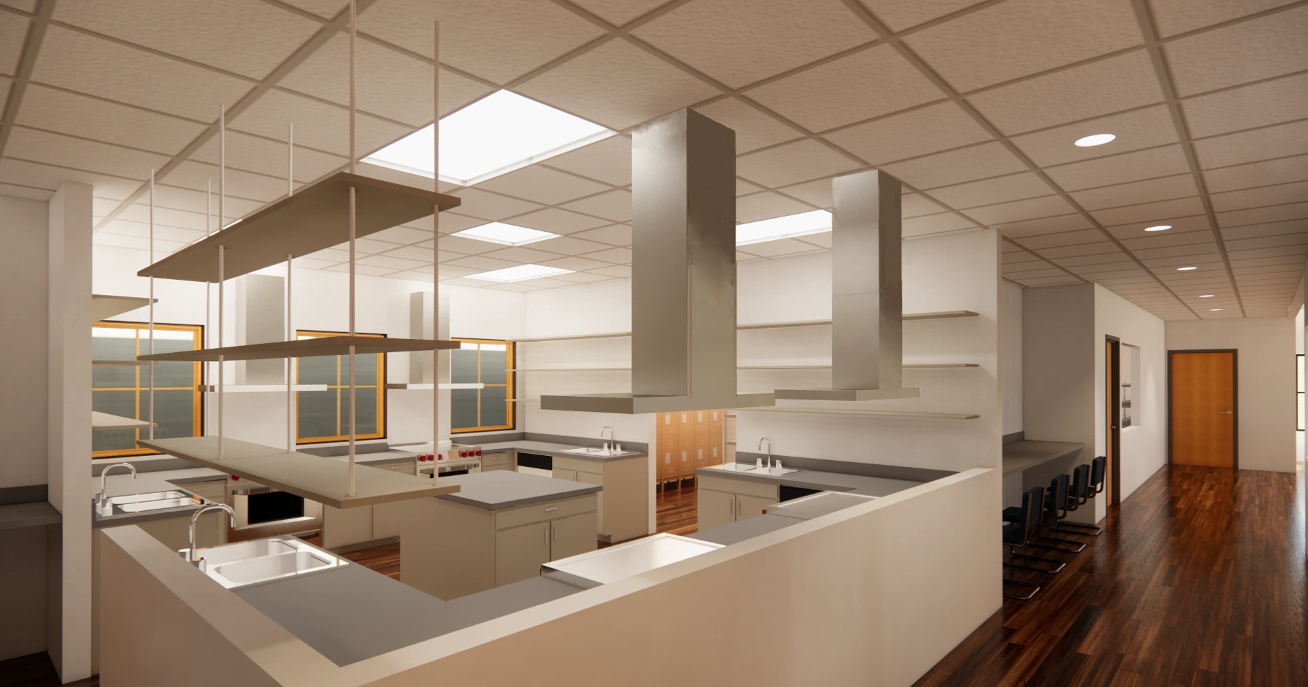 A modern, well-lit kitchen with multiple workstations, featuring overhead shelves, stainless steel countertops, and a warm wooden floor. Large windows in the background allow natural light to brighten the space.